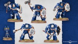 Five Space Marine Assault Terminators are displayed, each wearing iconic blue power armor and equipped with various weapons, including thunder hammers and storm shields. The miniatures feature detailed designs, with some having unique head options and tilting plates adorned with purity seals and badges. The background is a subtle gradient, enhancing the focus on the intricately crafted models.
