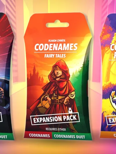 Three expansion packs for the party word game Codenames are displayed: "Sci-Fi," "Fairy Tales," and "Cute Critters." Each pack features vibrant artwork, with the "Sci-Fi" pack showcasing a character in a futuristic setting, the "Fairy Tales" pack depicting a girl in a red cloak against a colorful forest backdrop, and the "Cute Critters" pack featuring a playful panda. Each pack is labeled as an "Expansion Pack" and indicates compatibility with either Codenames or Codenames Duet.