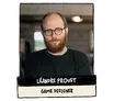 A man with a beard and glasses, wearing a black shirt, posed indoors with blurred industrial background. Text below reads: "LÉANDRE PROUST GAME DESIGNER."