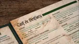 A close-up of a printed tabletop RPG pamphlet page titled "Parrot Borg". Visible text includes stat blocks for creatures: "Rival Bird" (HP 6, flight 100/turn), "Soldier" (HP 6, musket pistol), and "The Python" (HP 10, no armor). Flavor text describes a "smelly eagle drawl" and "creepy raven."