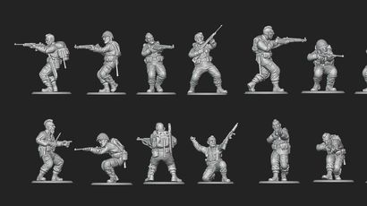 A collection of 28mm scale miniatures representing American soldiers from World War II is displayed, featuring various poses and stances. The figures include Airborne paratroopers, Rangers, and other military personnel, all intricately detailed and rendered in a metallic finish. The arrangement showcases multiple soldiers aiming weapons, gesturing, and preparing for action, highlighting the diversity of the U.S. armed forces during the 1944 campaign to liberate France.