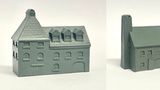 A detailed model of a building designed for 6mm scale wargames, featuring a sloped roof with three dormer windows and a textured surface that resembles slate. The facade includes several arched and rectangular windows, along with a large door at the base, all rendered in a light gray resin. The overall design suggests an industrial style, suitable for various historical or modern warfare settings.