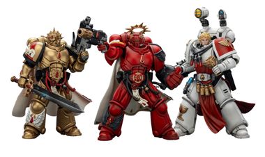 Three action figures representing Blood Angels Space Marines stand side by side. The first figure on the left is clad in red armor, holding a gun, and features intricate detailing. The central figure, also in red, has a prominent golden halo and a cape, while the figure on the right wears white armor with red accents and is equipped with various accessories, including a holstered weapon and a mechanical arm.