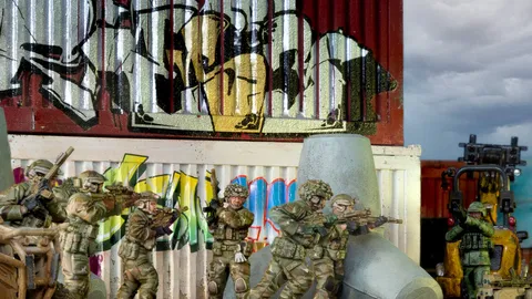 Five toy soldiers in camouflage aim rifles behind a graffiti wall.