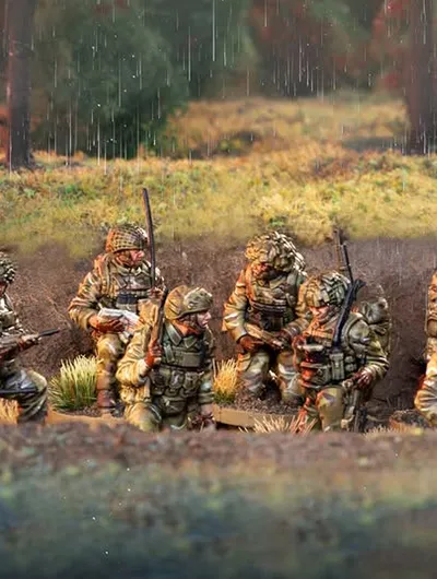 A group of six British army miniatures is depicted in a natural setting, with a backdrop of greenery and a hint of rain. The soldiers are dressed in modern camouflage uniforms and equipped with various weapons, including rifles and gear typical of contemporary military operations. They are positioned in a tactical formation, some seated and others standing, showcasing a range of unique sculpts that highlight their individual poses and details.