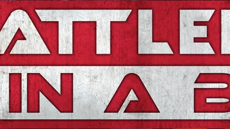 A bold graphic features the text "BATTLEFIELD IN A BOX" prominently displayed in large, stylized letters. The background is a textured red, contrasting with the white and silver elements of the text. The overall design conveys a strong, dynamic feel, suitable for a tabletop gaming context.