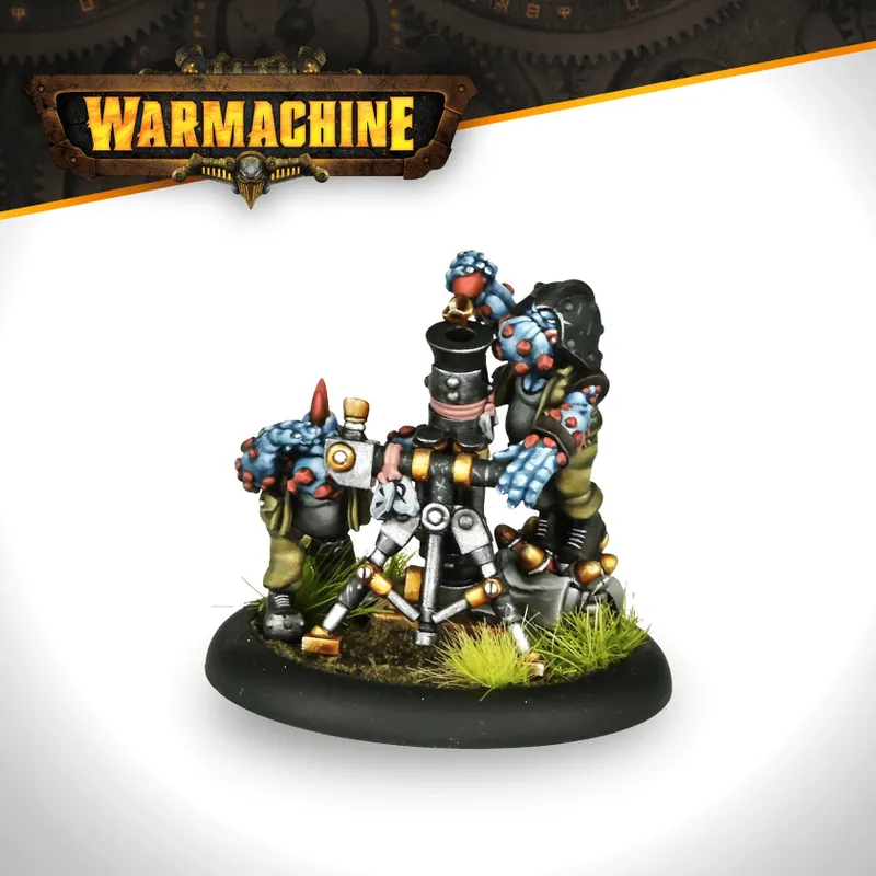 A trio of trollkin figures from the Southern Kriels Kithguard army is depicted, with two standing beside a mortar. One trollkin, wearing a black vest and holding a mortar tube, has blue skin adorned with red spots. The other, with a more robust build, is positioned to the left, gripping a lever on the mortar. The base features tufts of green grass, enhancing the scene's dynamic feel.
