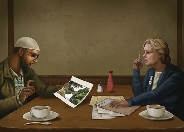 Two people at a table with coffee, a photo, and papers; one raises a finger.