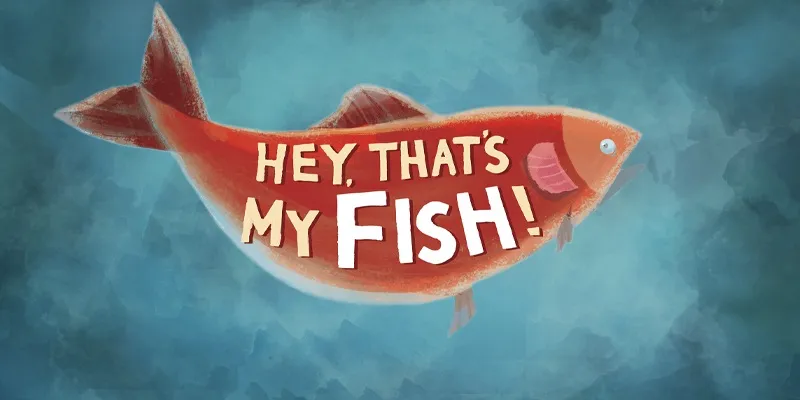 A stylized illustration of a fish, prominently featuring the title "HEY, THAT'S MY FISH!" in bold, playful lettering. The fish is depicted in a vibrant reddish-orange color with a slightly whimsical design, set against a soft, blue-toned background that suggests an underwater environment. The overall composition conveys a fun and engaging theme, suitable for a family-friendly board game.