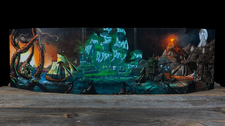 A vibrant Gamemaster screen features a dramatic scene of a ghostly ship with glowing sails navigating turbulent waters, set against a backdrop of a volcanic island erupting with fiery lava. The left side displays a smaller pirate ship, while the right side showcases rocky terrain and a shipwreck. The artwork incorporates dark colors with luminous green and orange elements, enhancing the adventurous and perilous atmosphere of the pirate theme.