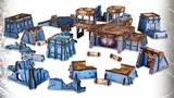 A collection of tabletop gaming terrain pieces in a futuristic style, featuring various structures such as buildings, platforms, and ruins. The pieces are predominantly blue with brown accents, showcasing intricate details and textures. Some structures are elevated, while others are flat, creating a diverse landscape suitable for gaming scenarios.