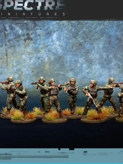 A group of ten miniatures representing a North Korean infantry squad is displayed, featuring soldiers in camouflage uniforms and helmets. They are equipped with Type 88 rifles and RPK-74s, with some holding rifle grenades. The base is adorned with tufts of grass, enhancing the military theme against a textured blue background.