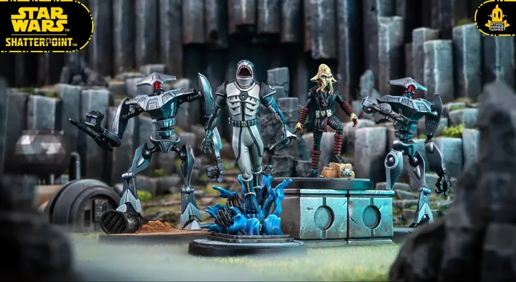 A detailed scene showcases several miniatures from the Star Wars: Shatterpoint game. In the foreground, a Quarren character stands on a base with blue, swirling water effects, while a humanoid figure in a gray suit, holding a weapon, is positioned nearby. To the left, a droid with a sleek design and red accents is poised, and in the background, a second droid stands ready for action against a backdrop of rocky terrain and structures, enhancing the dynamic atmosphere of the scene.