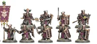 A group of five Zharrdron warriors stands in a dynamic formation, each clad in dark, ornate armor with intricate detailing. They wield a mix of weapons, including swords and shields, with some featuring glowing green accents. The warriors are set against a simple base with tufts of grass, emphasizing their imposing presence and the dark, industrial aesthetic of their design.