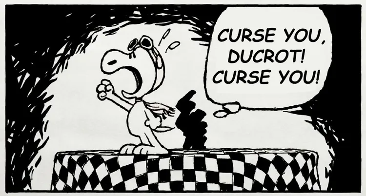 A cartoon illustration features a character resembling a small, anthropomorphic dog with a large head and expressive eyes, wearing aviator goggles and a scarf. The character stands on a checkered platform, dramatically shouting the text 