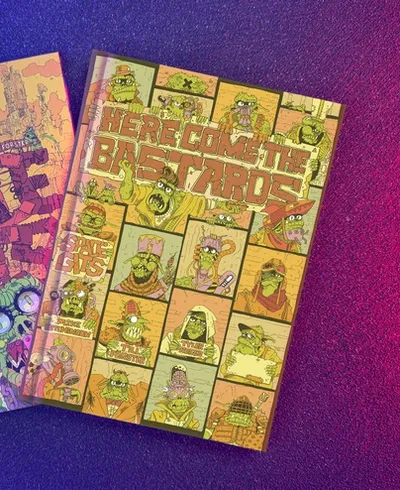 Two hardcover books are displayed against a gradient background of purple and blue. On the left, the book titled "Space Gits" features a colorful, chaotic illustration of space orcs amidst a whimsical landscape, with bold, stylized text. On the right, "Here Come The Bastards" showcases a vibrant cover filled with various orc characters in a comic strip style, prominently featuring the title in large, eye-catching letters. Both books reflect the playful and irreverent theme of the game.