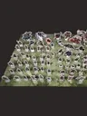 Cardboard standees of fantasy characters and creatures on a green grid map.