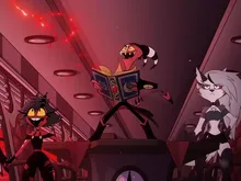 Two cartoon characters in a dimly lit, red-lit room. One stands on a desk reading an open book with ornate designs, wearing a black robe and pointed hat. The other, seated, has spiked hair, a black outfit, and a wide grin.