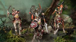 A trio of elven centaur models from the Kurnoth’s Heralds warband stands prominently in a lush, forested setting. Each figure is intricately detailed, featuring ornate armor and antlered helmets, with vibrant colors highlighting their unique designs. The central figure wields a spear and shield, while the others are posed with weapons, showcasing their readiness for battle amidst a backdrop of moss and twisted branches.