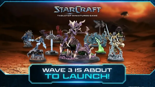 Six miniature figures on a tabletop: a purple Zerg creature with wings and claws, a Terran soldier with a gun, a green Zerg figure, a Terran ghost in white armor, a Protoss warrior with a sword, and a Protoss commander with a staff.