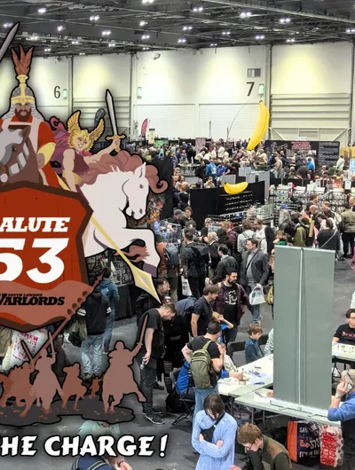 A bustling scene from SALUTE 53, Europe's largest independent wargames show, held at the London ExCel. The image captures a crowded exhibition hall filled with attendees exploring various vendor stands, with a prominent graphic overlay featuring the event's logo and artwork of a knight, a horse, and other characters. The atmosphere is lively, showcasing the excitement and engagement of the wargaming community.