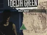 A person in dark clothing holding a firearm, with a blurred face. The background features a textured, worn wall with a green triangular symbol. Above the person, the text "HOLY WAR" is visible. At the top of the image, partially obscured text includes "DELTA GREEN".