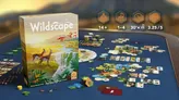 Board game with blue play area showing scattered hexagonal tiles depicting landscapes, buildings, and wildlife. Four icons with text: "14+", "1–4", "30’×", and "3.25/5". Player cards and resource tokens visible.