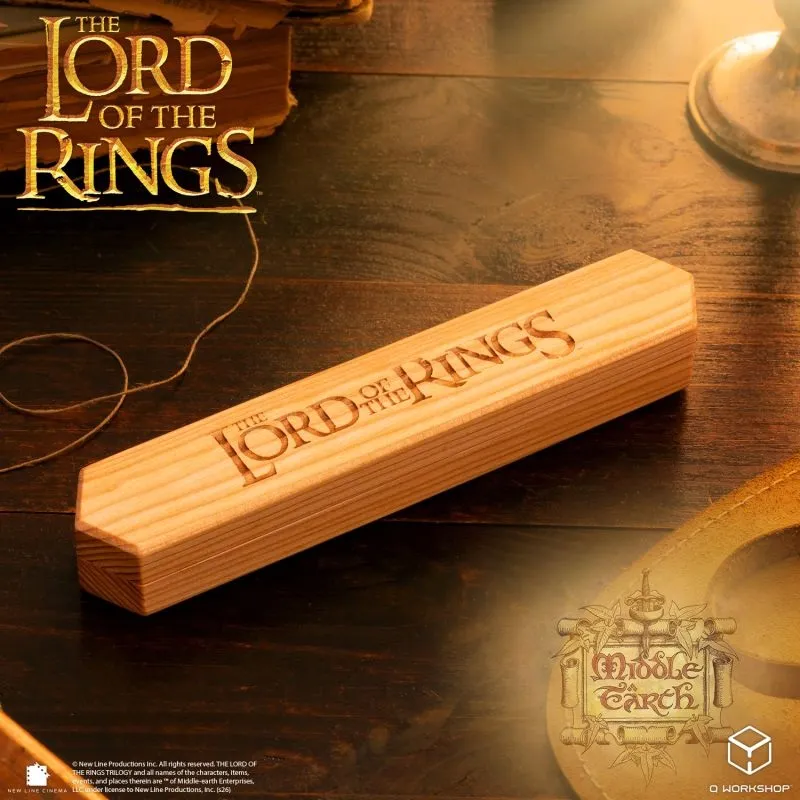 Wooden box with "The Lord of the Rings" carved on it, Middle-earth logo, and background text.