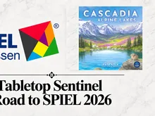 Cover art for Cascadia: Alpine Lakes board game showing a mountain lake scene with snow-capped peaks, green forests, and wildlife including a moose and beaver. Title reads "Cascadia Alpine Lakes." Logo for Spiel des Jahres 2026 and "Drop Sentinel" text visible.