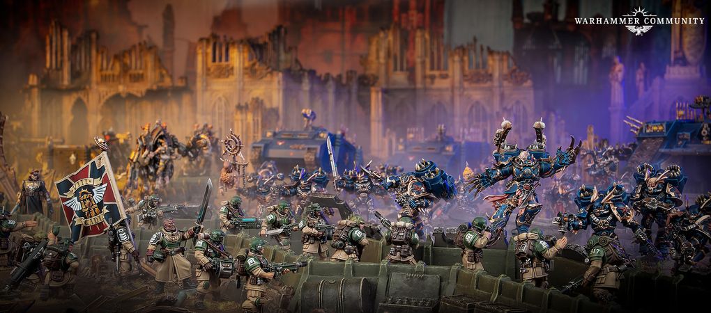 A dynamic scene features a group of intricately detailed Warhammer 40,000 miniatures engaged in battle. In the foreground, several armored soldiers in green uniforms are positioned behind a barricade, aiming their weapons. In the background, imposing figures in dark blue armor, adorned with spikes and intricate designs, advance menacingly, showcasing a mix of futuristic and gothic architecture in the blurred backdrop.