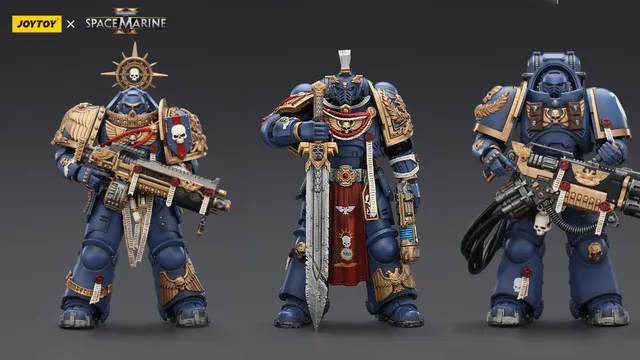Three detailed action figures from the Warhammer 40,000: Space Marine series are displayed against a dark background. On the left, the Relic Primus Armor figure holds a heavy bolt rifle, adorned with intricate decorations, including a skull emblem and a shield. To the right, the Heavy Artificer Armor figure wields a large combat blade, featuring a flowing red cape and various honor ribbons, showcasing the iconic blue and gold color scheme of the Ultramarines chapter.