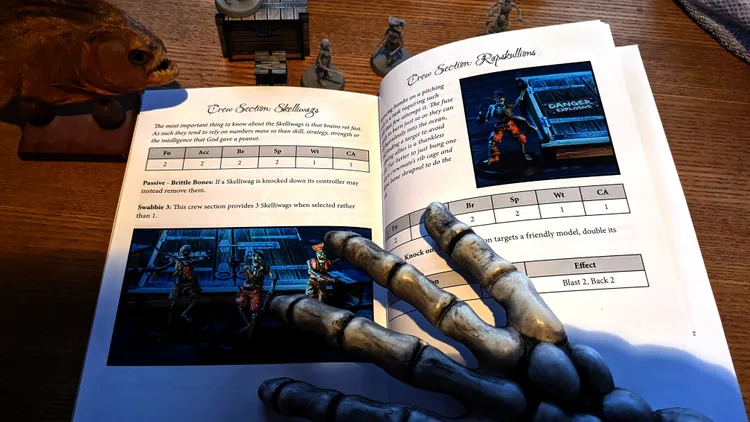 A tabletop scene featuring a partially open rulebook for the game 