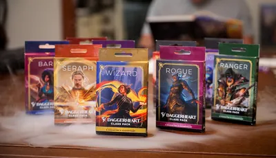 Four colorful Class Packs for the Daggerheart tabletop roleplaying game are displayed prominently. The packs are labeled "BARBARIAN," "SERAPH," and "WIZARD," each featuring unique artwork representing the respective classes. The background includes a soft, smoky effect, enhancing the fantasy theme of the scene.