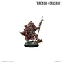 A detailed miniature figure stands prominently, dressed in a striking red robe adorned with intricate patterns and symbols. The figure wears a distinctive triangular headpiece and holds a spear in one hand, while the other hand is positioned as if ready to wield a weapon. The base features a rocky terrain, suggesting a battlefield setting, and the overall design reflects the grimdark aesthetic of the Trench Crusade game.