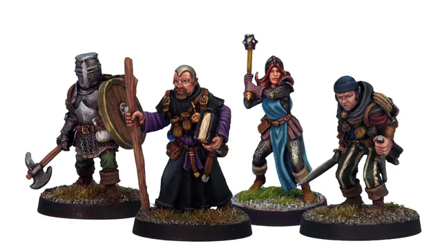 A group of four detailed miniatures representing classic adventurer character classes. On the left, a knight in armor holds a shield, followed by a robed figure with a book and staff. The third figure is a female illusionist in a blue dress with a staff, and on the right, a rugged fighter brandishes a sword. Each miniature is mounted on a round base with grass detailing.
