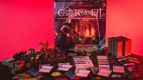 Castle Ravenloft Board Game box, miniatures, cards, and tokens on a table.