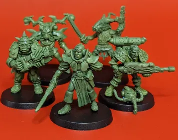 A group of five 28mm scale sci-fi miniatures is displayed against a bright red background. The figures include a Space Commando wielding a rifle, a Starchild with a distinctive helmet, an Assault Goar holding a sword, a Space Orc with a large gun, and a Voidborn equipped with various gadgets. Each miniature features intricate details and a classic old-school aesthetic, showcasing the unique character and charm of the RT Adventurer Pack II from Satyr Art Studios.
