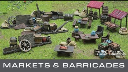 A detailed tabletop scene features a variety of marketplace elements, including wooden stalls, barrels, crates, and bags, all set on a grassy surface. The scene showcases multiple tables with assorted food items and decorative pieces, emphasizing the bustling atmosphere of a market. Above the scene, the text "GENERAL ACCOUTREMENTS" and "MARKETS & BARRICADES" is prominently displayed, indicating the theme of the set.
