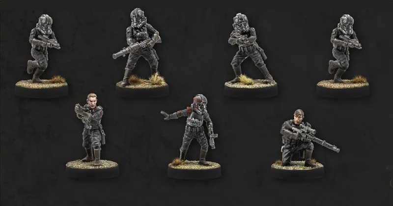 Seven miniatures are displayed against a dark background, showcasing the Imperial Special Forces from Star Wars: Legion. The figures include various troopers in tactical gear, some holding blasters and others in dynamic poses, with details like helmets and insignia visible. The bases are textured with grass, adding to the realistic appearance of the miniatures.