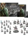A collection of miniatures and game components from the Soulblight Gravelords Deathrattle Army Set is displayed. In the center, a mounted Wight King stands prominently, surrounded by five Barrow Knights and 20 Barrow Guard figures, all intricately detailed. The set also includes the Battletome: Soulblight Gravelords and a set of warscroll cards, with the packaging featuring dark, atmospheric artwork that complements the undead theme.