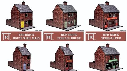 A collection of six 28mm scale MDF buildings is displayed, featuring a red brick design. The buildings include a "Red Brick House with Alley," "Red Brick Terrace House," "Red Brick Terrace Pub," "Small Red Brick Terrace House," "Small Red Brick Terrace Shop," and "Red Brick Terrace Store." Each building showcases distinct features, such as varying door colors and signage options, suitable for various historical genres.