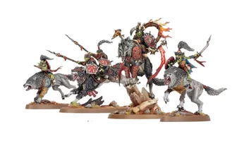 A dynamic display of goblin miniatures features several wolf-riding figures, including a prominent leader adorned with armor and a fiery banner. The miniatures are intricately detailed, showcasing vibrant colors and various weapons, set against a rocky base with tufts of grass. Additional wolf-riders and a chariot can be seen, emphasizing the theme of mobility and aggression in this new release.