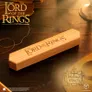 Wooden box with "The Lord of the Rings" carved on it, Middle-earth logo, and background text.