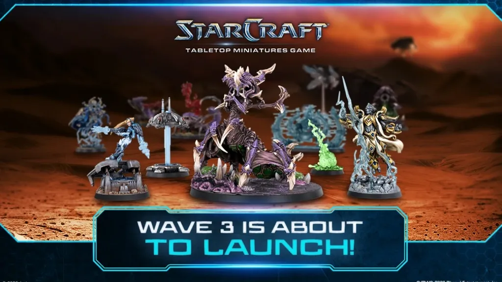 Six miniature figures on a tabletop: a purple Zerg creature with wings and claws, a Terran soldier with a gun, a green Zerg figure, a Terran ghost in white armor, a Protoss warrior with a sword, and a Protoss commander with a staff.