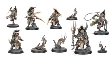 A collection of six intricately designed miniatures representing the Sha’dar Hunters from Necromunda, accompanied by their Arthromite spinewyrms. The hunters are clad in rugged, post-apocalyptic armor, featuring various weapons and gear, while the spinewyrms exhibit a segmented, menacing appearance. The bases of the miniatures are textured to resemble the harsh terrain of the Ash Wastes, enhancing the overall theme of survival in a desolate environment.