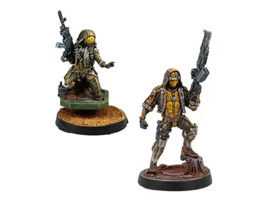 Two miniatures from Corvus Belli's upcoming releases are displayed. On the left, a figure in tactical gear holds a rifle, standing on a textured base, while on the right, another character in a similar outfit poses with a sidearm, set on a rocky base. Both miniatures feature intricate details and a color palette of earthy tones and metallic accents, showcasing their sci-fi aesthetic.