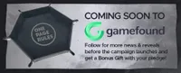 A foldable dice tray with a hexagonal shape, featuring the "One Page Rules" logo engraved on its surface, is set against a textured gray background. The text "COMING SOON TO Gamefound" is prominently displayed, along with a call to action encouraging viewers to follow for updates and receive a bonus gift with their pledge. The overall design emphasizes the upcoming campaign for Grimdark Future: Broken Truth.